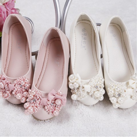 pink and white flat shoes with bows and pearls are girlish, statement and very catchy