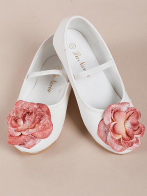 white shoes with straps and pink fabric flowers are cool and unusual accessories for a flower girl