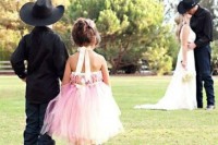 a pink strapless tulle knee dress with brown cowboy boots is a look inspired by the bride’s outfit