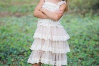 a blush ruffle knee dress with white lace, cowboy boots and a lace tie on the head for a super cool look