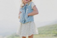 a white lace mini dress, a blue denim waistcoat, brown fringe boots and a floral crown for a rustic wedding