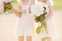 short white ruffle dresses with thick straps, cowboy boots, white lace headbands for a cute and fun summer rustic wedding