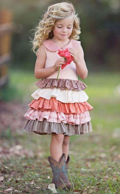 a sleeveless ruffle layered knee dress with no sleeves but a collar, cowboy boots and a hair tie for a boho or rustic wedding
