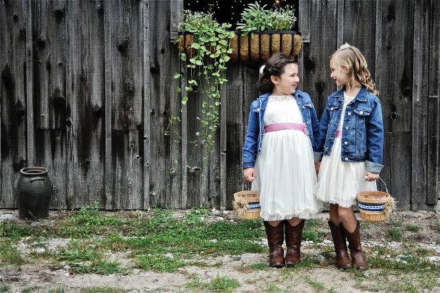 white midi dresses with tulle skirts, denim jackets, cowboy boots and baskets for a spring or fall rustic wedding
