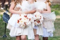 white off the shoulder ruffle knee dresses paired with brown cowboy boots and with fabric flower headbands for a cute look