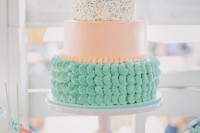 a romantic and pastel wedding cake with a mint sugar tier, a peachy sleek tier and a sprinkle one plus pastel candies on top
