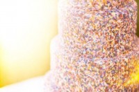 a four-tier wedding cake fully covered with sprinkles is a lovely and bright idea to rock