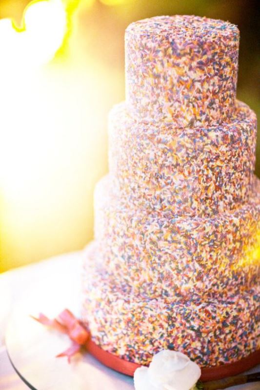 a four-tier wedding cake fully covered with sprinkles is a lovely and bright idea to rock