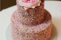 a two-tier sprinkle wedding cake topped with pink and white blooms is a lovely idea for a modern whimsy wedding