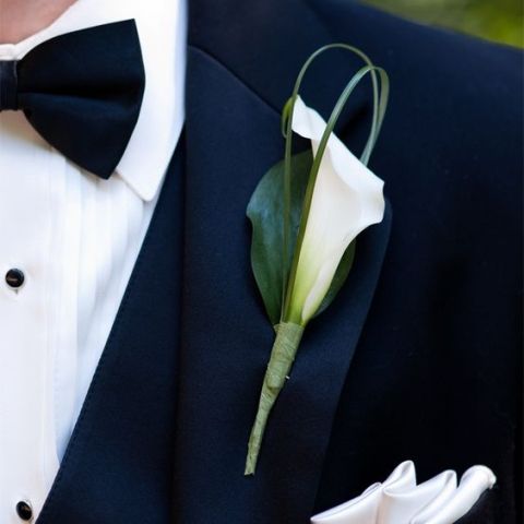 a white calla lily and greenery wedding boutonniere is a chic and lovely idea of a wedding accessory