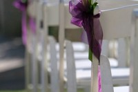 a white calla lily arrangement with a purple ribbon is a chic decoration for the aisle chair, it can be a nice solution to add interest to the space