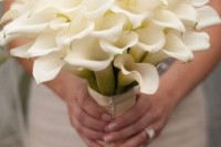 a beautiful white calla lily wedding bouquet with a white ribbon wrap is a chic idea for a spring or summer wedding