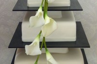 a large three tier wedding cake with cascading calla lilies is a chic and elegant idea of a wedding cake with a sophisticated feel