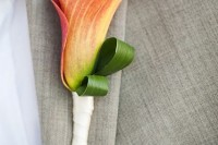 a peachy calla lily boutonniere is a chic and stylish idea for a wedding, it adds color and interest to the look