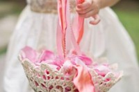 a doily and colorful ribbon basket with colorful petals is a basket with a vintage feel