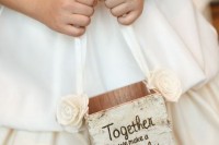 a plywood box covered with bark, a ribbon handle and fabric blooms for a rustic wedding