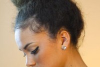 straightened curls done into a top knot for a more elegant and sleek look