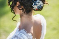 a curly updo with a bead and sequin hairpiece and some bangs is romantic and very chic