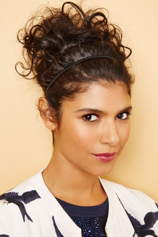 a curly updo with a hair vine to keep it in place is a cool casual option