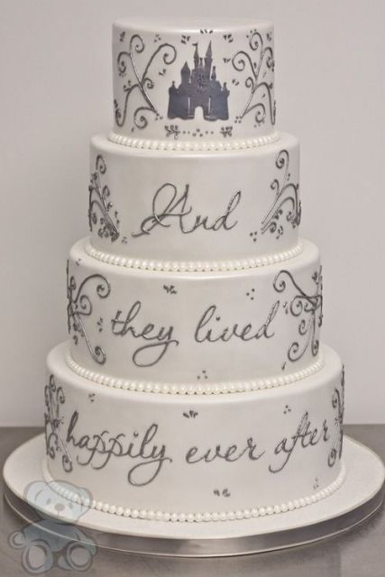 a white wedding cake decorated with grey decor and quotes and pearls for a Disney themed wedding
