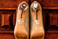 sparkling gold wedding shoes with Micckey Mouse heads and Disney letters on the bottoms