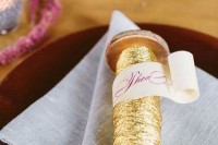 gold yarn and ribbons with a ribbon with the guest’s name is a veyr creative idea of a place card