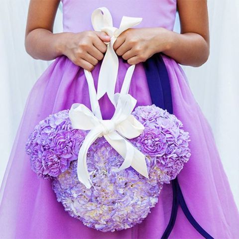 a purple flower Mickey Mouse head with a ribbon bow is a fun subsitute of a usual basket ith petals