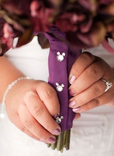 a purple bouquet wrap with rhinestone Micckey Mouse heads for decor is a fun and small touch