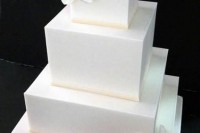 a minimalist white square wedding cake with white orchids is a timelessly elegant idea