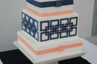 a cute wedding cake in navy and coral plus geometric patterns is a chic idea
