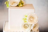 a small squre wedding cake in white decorated with fresh blooms is a timeless idea to rock