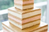 a naked square wedding cake with a simple gold calligraphy topper for a modern wedding