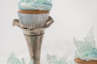 Frozen-themed wedding cupcakes with blue icing and clear blue shards on top look fantastic