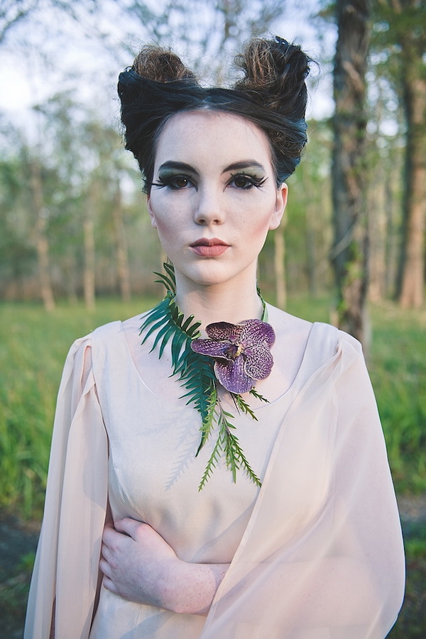 a Maleficent bride rocking her unique hairstyle, a bold makeup, a fresh orchid necklace and a neutral wedding dress