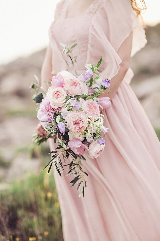 a beautiful and chic rose quartz wedding bouquet of peony roses and some cascading greenery is a beautiful idea to rock