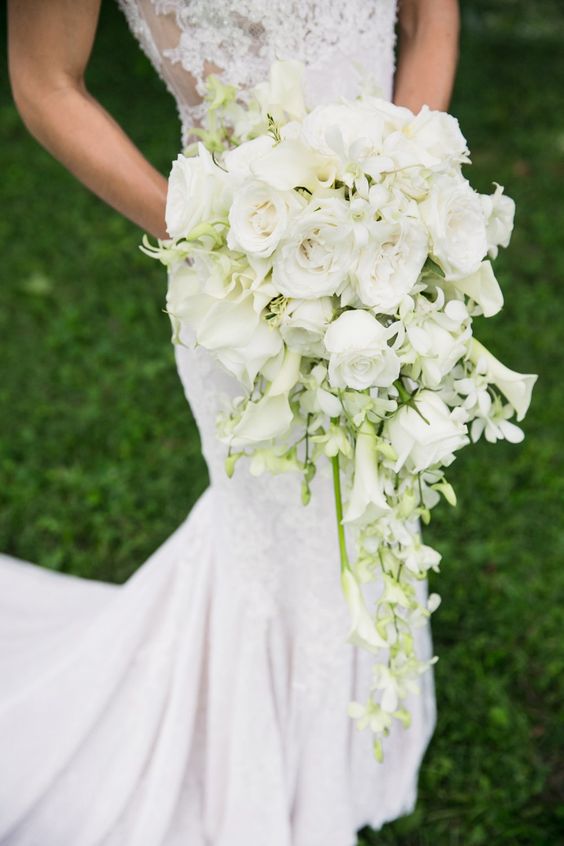 a beautiful white wedding bouquet of calla lilies and roses is a chic and stylish idea for a spring or summer wedding