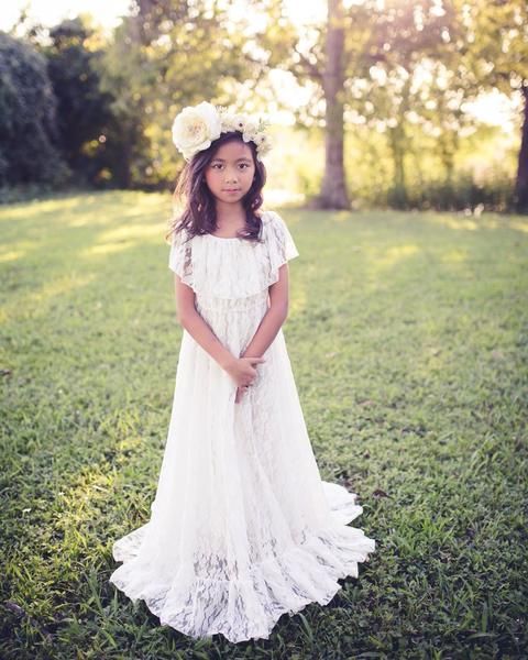 a boho lace maxi dress with a train, with a ruffle bodice and no sleeves, a floral crown for a boho look