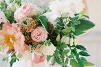 a bold dimensional wedding bouquet with rose quartz, white blooms and various greenery includng cascading is amazing