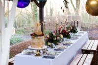 a chic and refined wedding tablescape with candelabras, moody florals, fuchsia candles for the Beauty and the Beast wedding