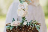 a classic basket with silk white rose petals and greenery is a cool idea for any wedding