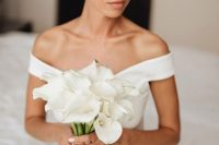 a classic white calla wedding bouquet perfectly matches the refined minimalist bridal look here