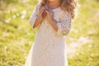a cute white lace knee dress with a high neckline, short sleeves and cowboy boots for a simple and chic look