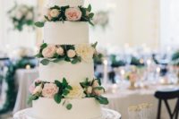 a cute white textural wedding cake with blush and neutral blooms and greenery is timeless
