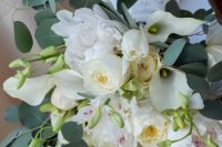 a delicate wedding bouquet of white callas, peonies and peony roses and some greenery is a lovely idea for spring or summer