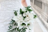 a fab wedding bouquet of white roses and calla lilies plus some greenery is a stylish idea for a spring or summer wedding