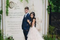 a fairytale book wedding backdrop with greenery is a very creative Disney wedding idea