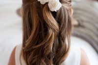 a half updo with twists and waves down, with white silk blooms will match a classic and formal flower girl look