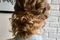 a loose curly updo with fishtail braid is neat and tame, it’s trendy and very boho-like
