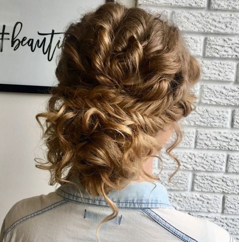 a loose curly updo with fishtail braid is neat and tame, it's trendy and very boho-like