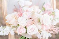 a lovely and dimensional wedding bouquet of white and light pink roses, astilbe and some other fillers is amazing for spring or summer